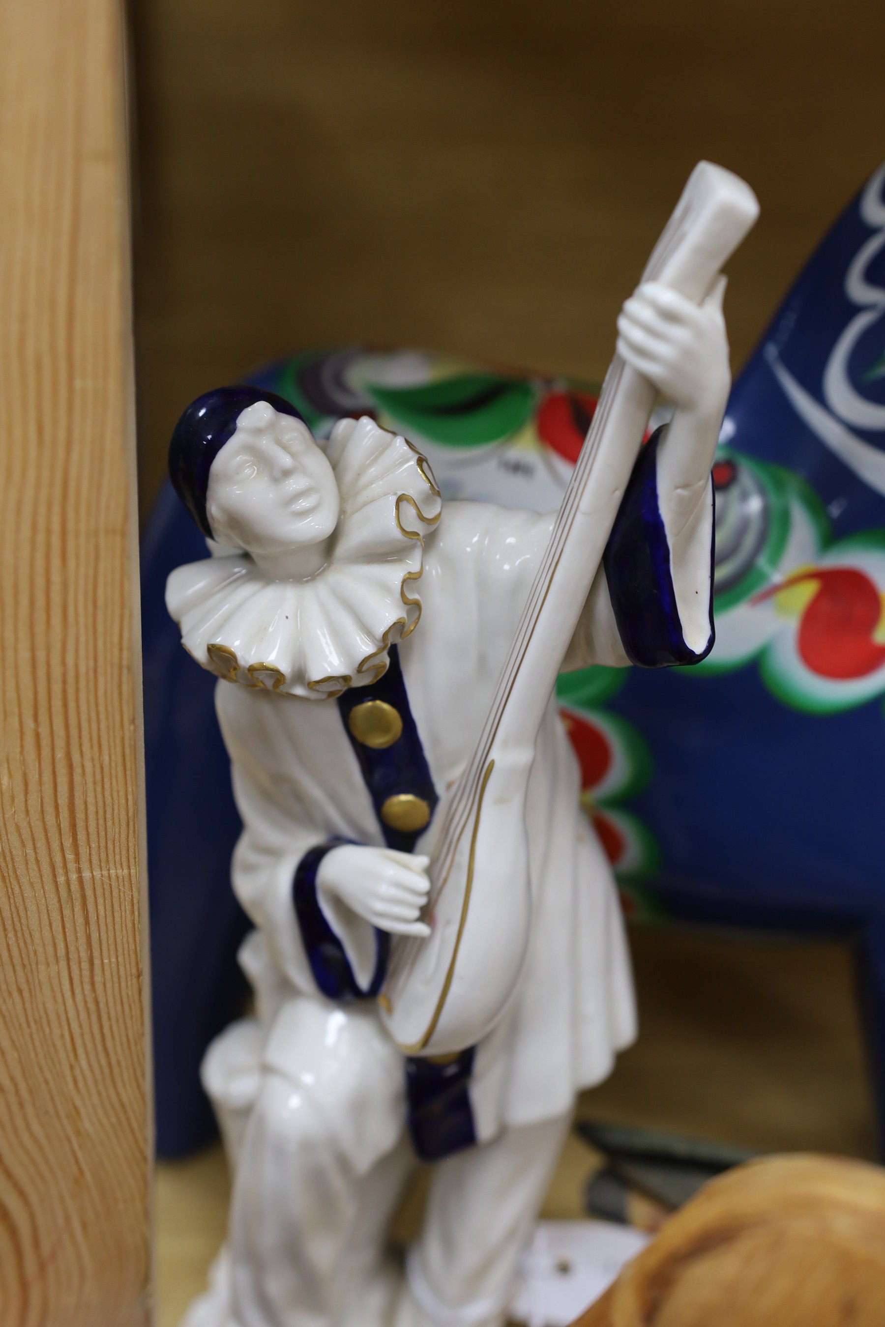A Spanish porcelain model of Pierrot playing a mandolin, blue and gilt decoration, H29, a Swedish painted wood horse and decorative items